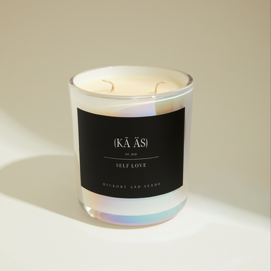 self love, hickory and suede scented candles iridescent white vessel