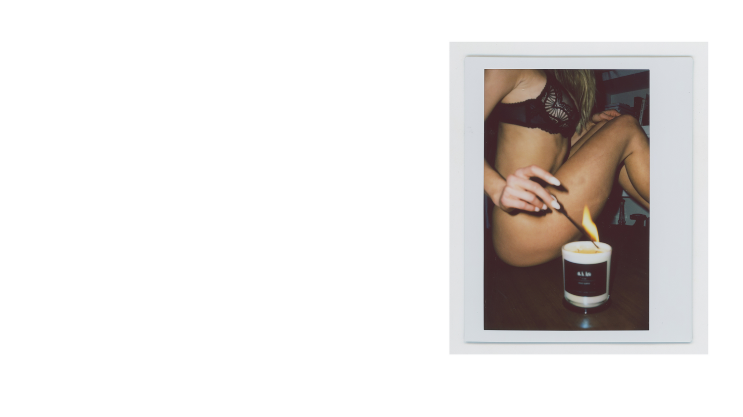 a polaroid image of a girl in lingerie lighting a kaas self love candle