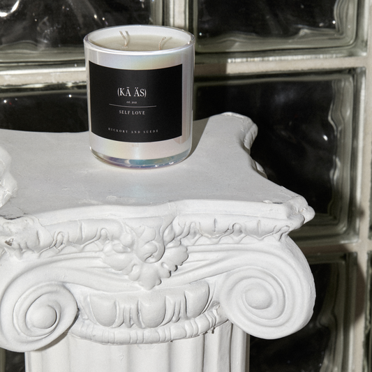 self love, hickory and suede scented candles iridescent white vessel